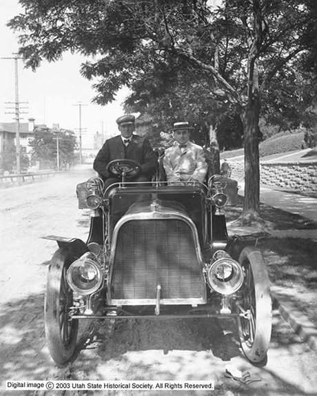 Samuel Newhouse with an unknown driver in a Maxwell(?) touring car. Photo was taken by Shipler Commercial Photographers in 1904 parked at 165 East South Temple in Salt Lake City.