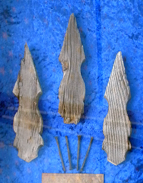 A shadowbox containing remnants of the original picket fence and nails.