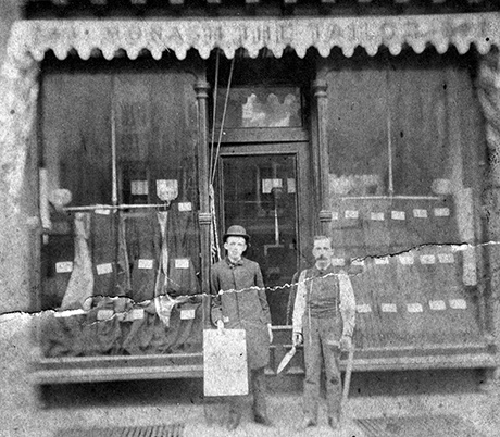 Isaac “Uncle Morris” Monash, to the right, stands with another gentleman in front of his shop in Charleston, South Carolina. 