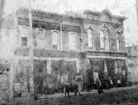 Front view of Monheimer Brothers store at 321 Harrison Avenue, corner of Harrison Avenue and 4th Street. 