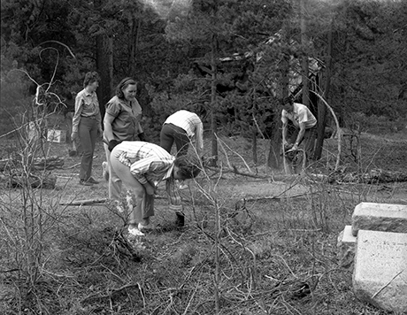 Community volunteers tending to the grounds in 1972 after years of neglect. The history of the structure (no longer present) to the upper right behind the trees in this photo is unknown.