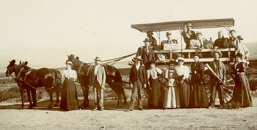 The sign held by Miss Friedlander reads: “This Way To The Kosher Picnic”: The word “Kosher” is written in Hebrew.